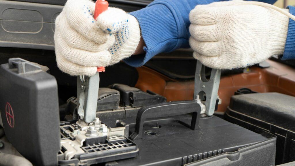 Jumper Cables Getting Connected To A Car Battery