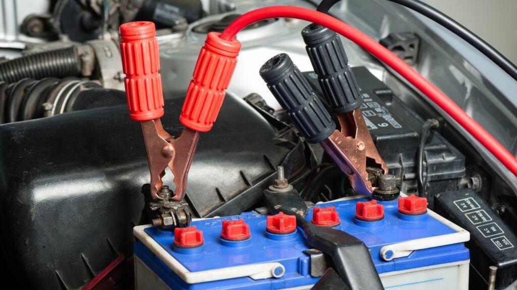 Jumper cable connected to a car battery