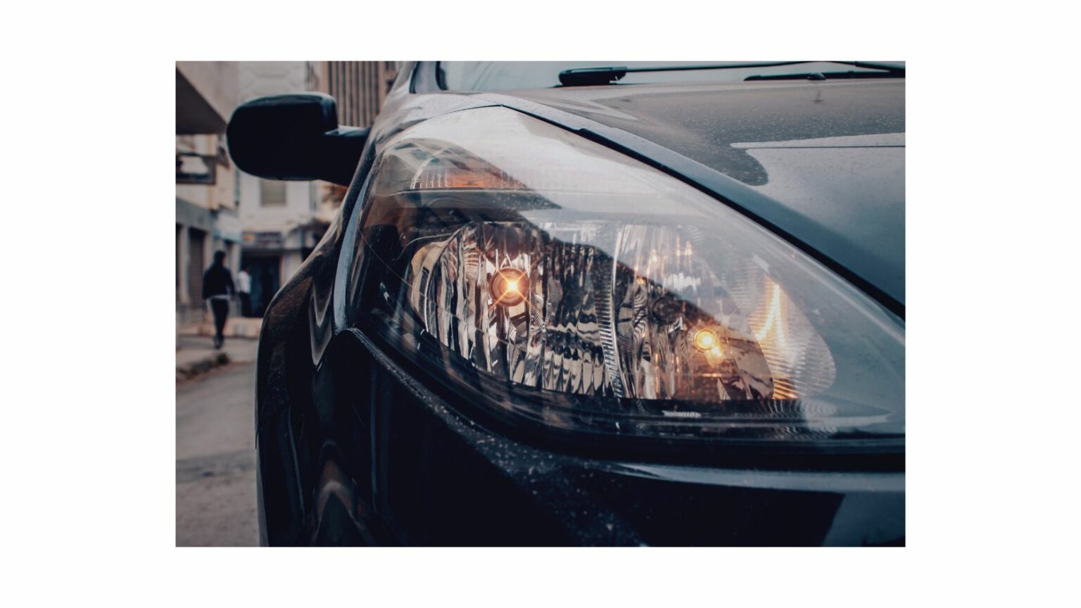 Dimmed Headlights Of A Car Thecarplus