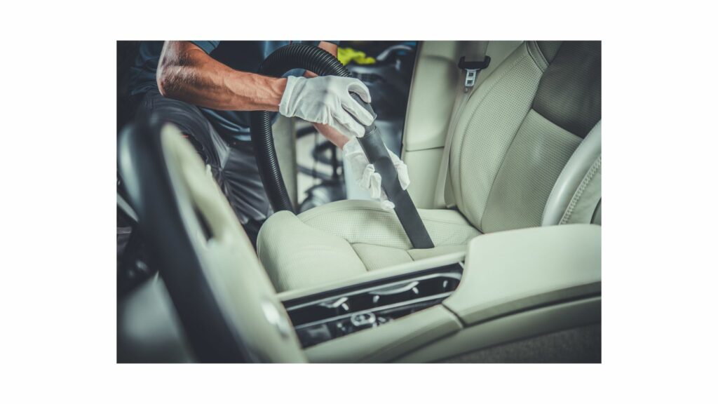 Vacuuming Car Interior Wearing Hand Gloves