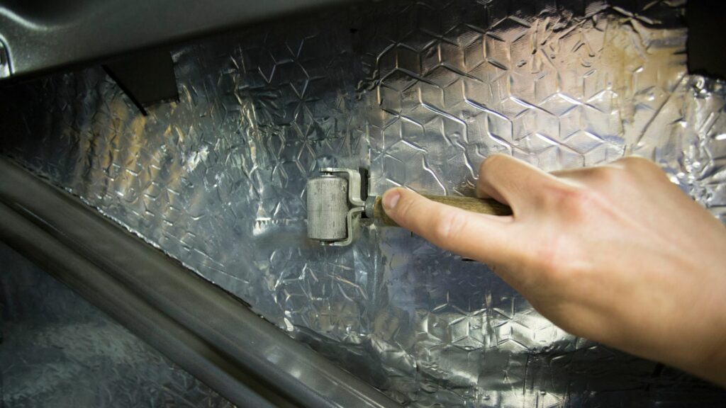 Rolling A Sound Deadening Mat in a Car