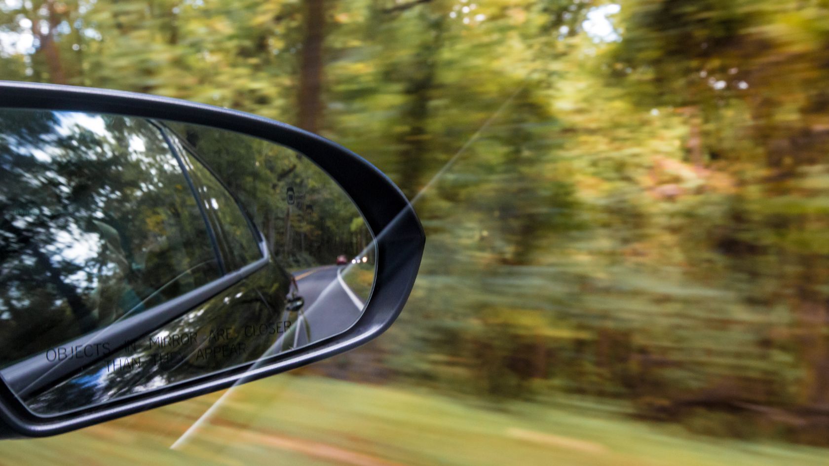 A View In The Car's Side Mirror