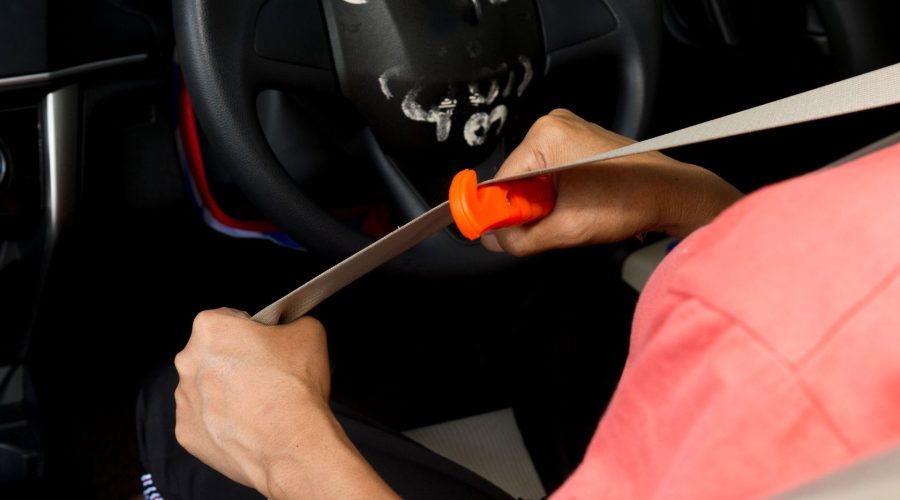 Cutting The Seat Belt With A Car Emergency Escape Tool