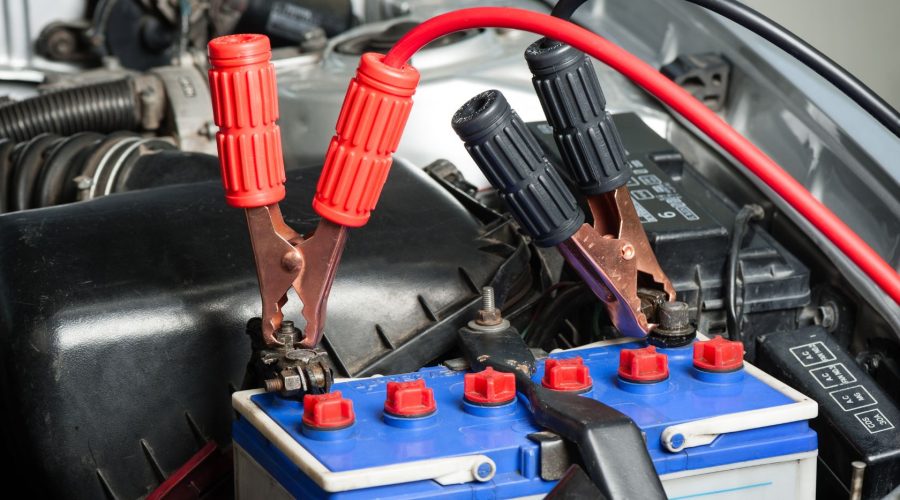 Jumper Cable Connected To A Car Battery