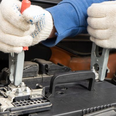 Jumper Cables Getting Connected To A Car Battery
